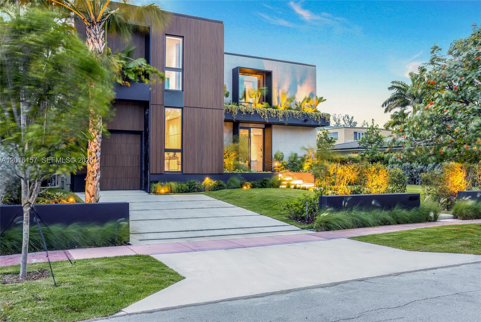 A modern two-story house features vertical wood-slat siding, large windows, and a landscaped front yard — 4550 N Jefferson Ave, Miami Beach FL 33140, MIAMI BEACH, FL
