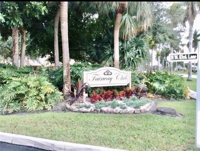 A sign for the Fairway Club stands in a landscaped garden with palm trees — 3600 NW 83rd Ln, Sunrise FL 33351, SUNRISE, FL