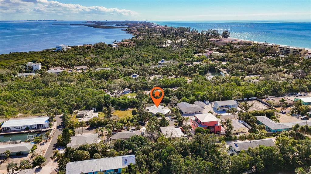 An aerial view shows a house marked with an orange pin surrounded by dense vegetation — 624 SAINT JUDES DRIVE, LONGBOAT KEY, FL