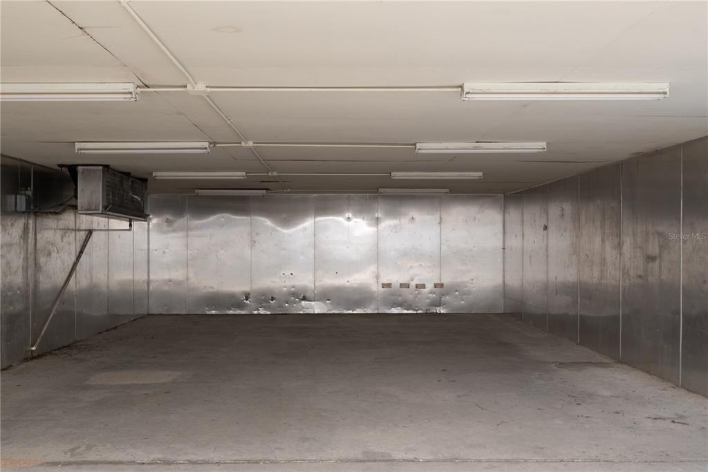 An empty walk-in cooler features metal walls, a concrete floor, and overhead fluorescent lighting — 5000 SE HWY 31 UNIT W, ARCADIA, FL