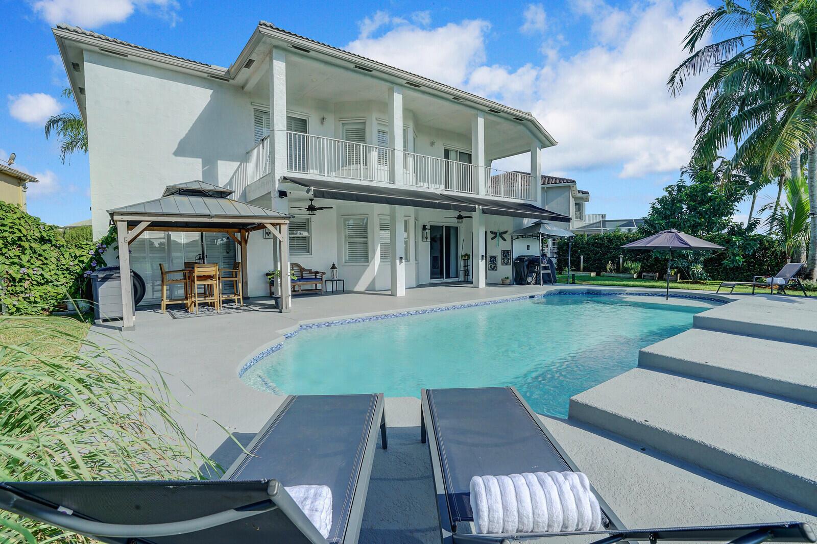 A two-story house with a balcony, patio, gazebo, and swimming pool in the backyard — 2176 Bellcrest Circle, Royal Palm Beach FL 33411, ROYAL PALM BEACH, FL