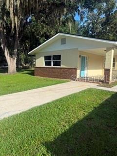 A single-story house with a brick base, light-colored siding, and a covered front porch — 3115 SE 11TH STREET, OCALA, FL