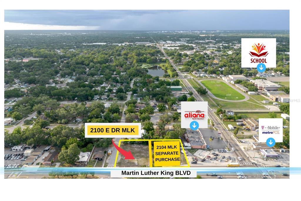 A vacant, grassy lot features a small building on the right and surrounding trees — 2100 E DR MLK, TAMPA, FL