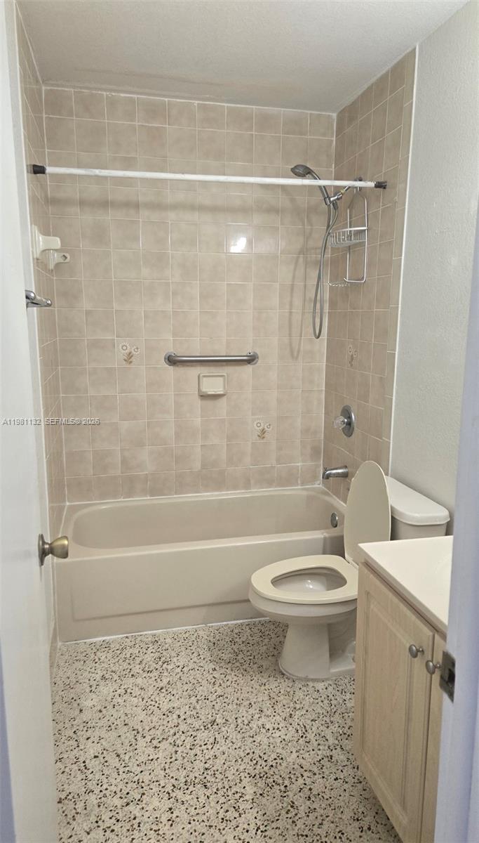 A bathroom features a beige bathtub with a showerhead, a toilet, and a vanity — 142 SW 18th ave # 30, Miami FL 33135, MIAMI, FL