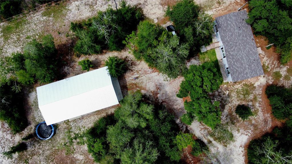 An aerial view shows a rectangular plot of land outlined in red containing trees — 29578 SW 63RD AVENUE, NEWBERRY, FL