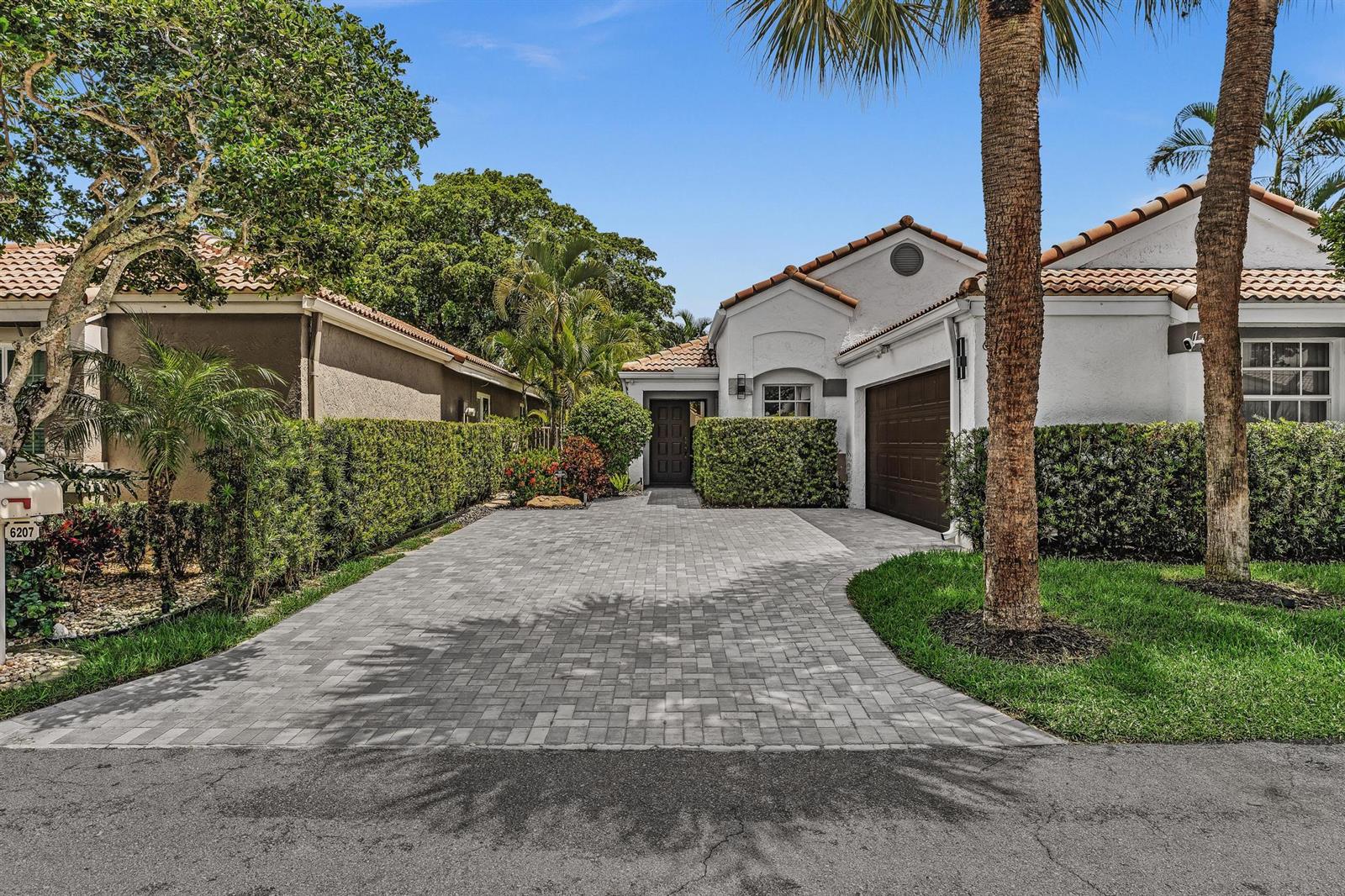 A single-story house with a paved driveway, a brown garage door, and manicured hedges — 6207 La Vida Terrace, Boca Raton FL 33433, BOCA RATON, FL