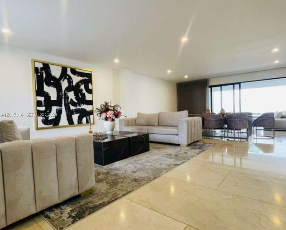A modern living room features a large abstract painting, light-colored sofas, and polished tile floors — 20 ST Loma Montesori Poblado, CO, CO
