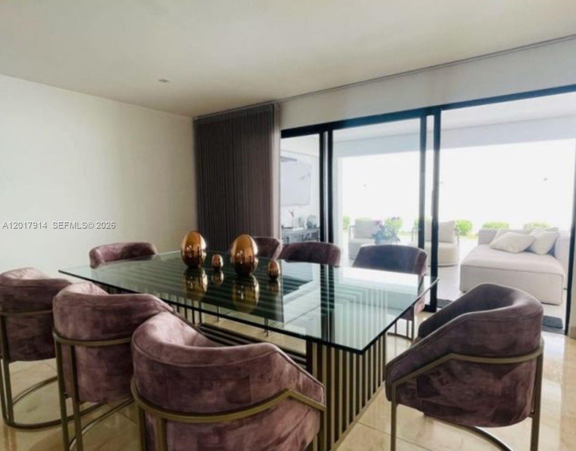 A dining room features a glass-topped table, velvet chairs, and floor-to-ceiling sliding glass doors — 20 ST Loma Montesori Poblado, CO, CO