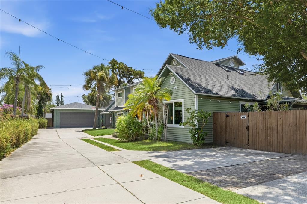 A green house with a long concrete driveway and a detached garage — 405 BAY POINT AVENUE, NOKOMIS, FL