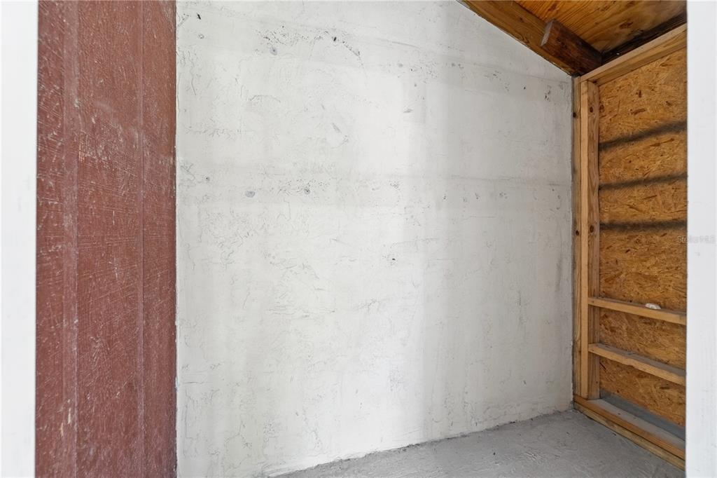 A small utility space features a white concrete wall and exposed wood framing — 3823 N OAK DRIVE UNIT K22, TAMPA, FL