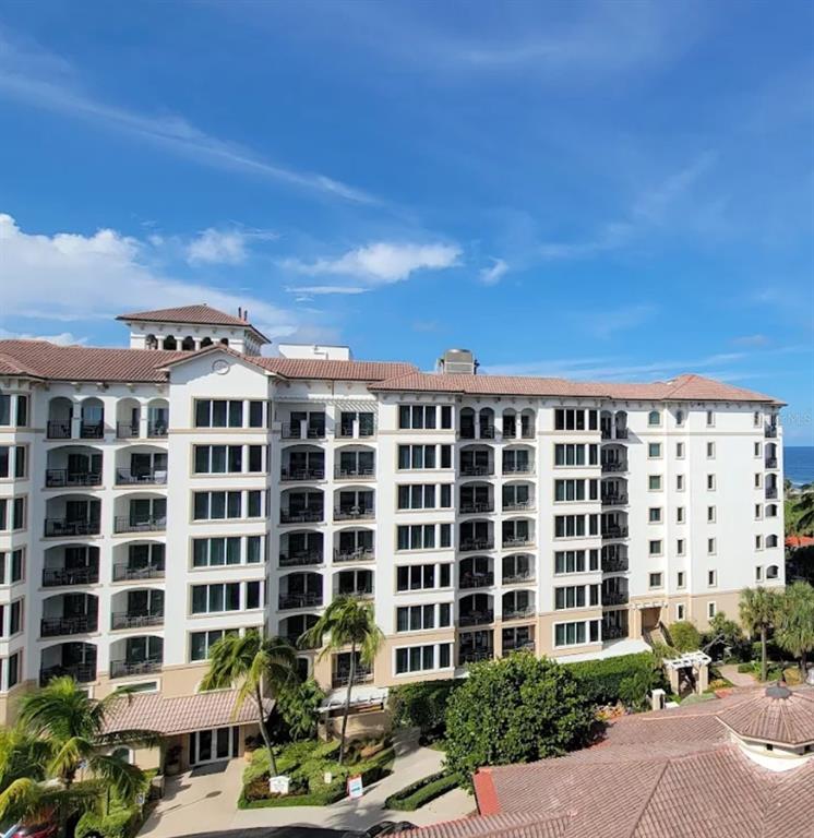 A multi-story resort building with balconies and a tiled roof under a blue sky — 71 S OCEAN AVENUE UNIT 8708, PALM BEACH SHORES, FL