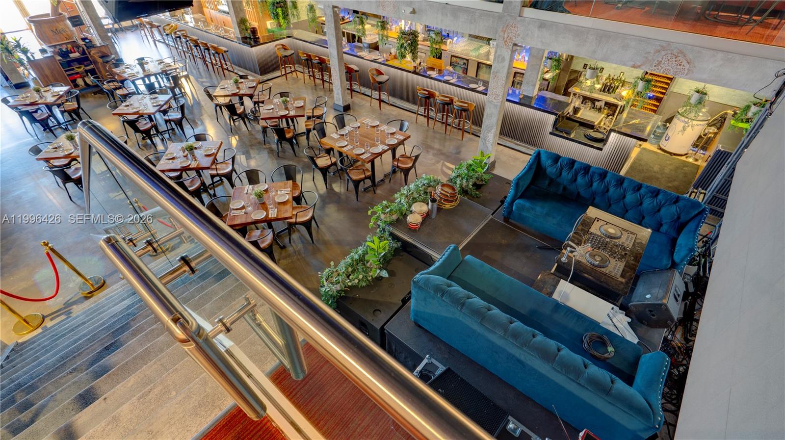 An elevated view of a restaurant interior featuring dining tables, a bar, and lounge seating — Restaurant for Sale, Miami FL 33135, MIAMI, FL