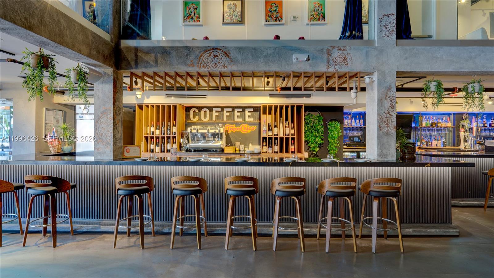 A bar area features a long counter with seven wooden stools and a coffee station — Restaurant for Sale, Miami FL 33135, MIAMI, FL