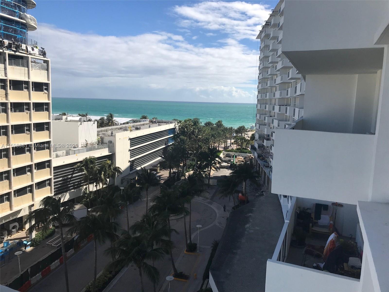 An elevated view shows a beachside street with palm trees between two large apartment buildings — 100 Lincoln Rd # 808, Miami Beach FL 33139, MIAMI BEACH, FL