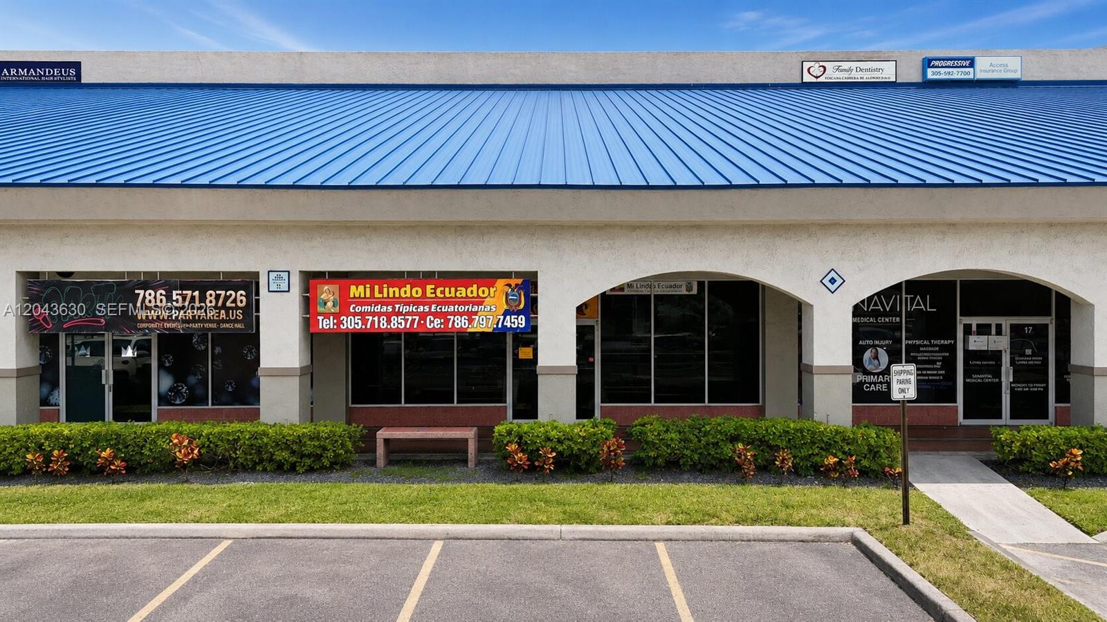 A commercial strip mall building features a blue metal roof and several storefront businesses — 8726 NW 26 ST # 18, Doral FL 33172, DORAL, FL