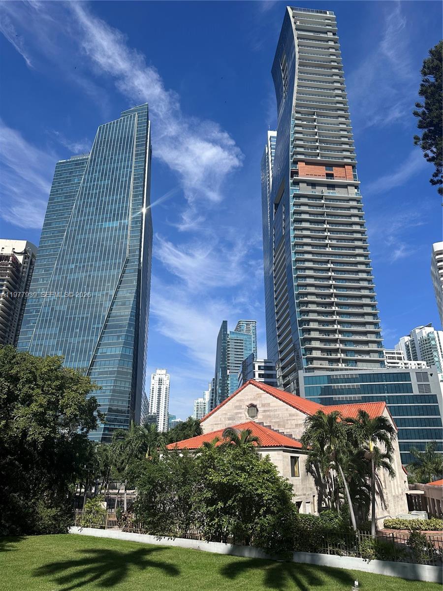 Modern glass skyscrapers rise behind a historic building with a red tile roof — 1541 Brickell Ave # B403, Miami FL 33129, MIAMI, FL