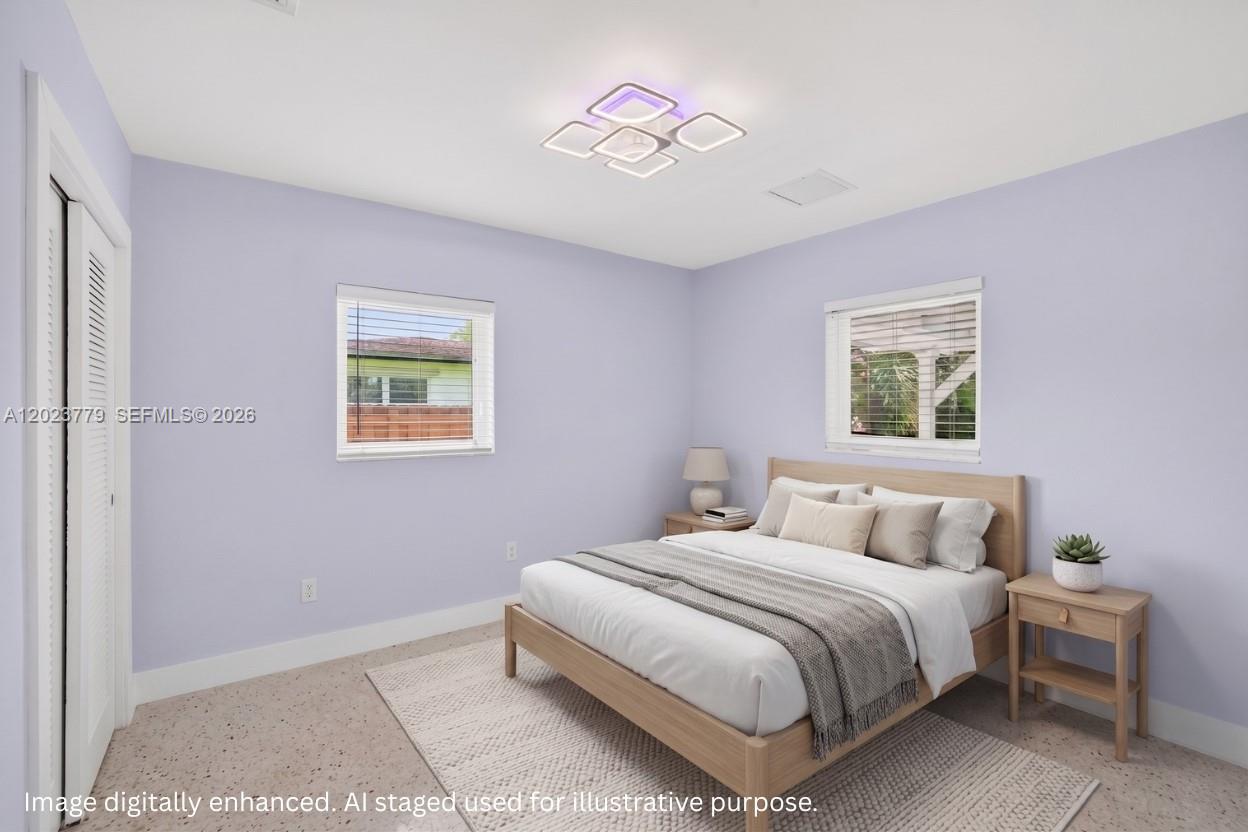 This is a digitally staged bedroom with light purple walls, a bed, and two windows — 709 NW 9th Ct, Hallandale Beach FL 33009, HALLANDALE BEACH, FL