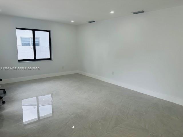 An empty room features white walls, recessed lighting, and light-colored tile flooring — 11870 SW 5th # 1, Miami FL 33184, MIAMI, FL