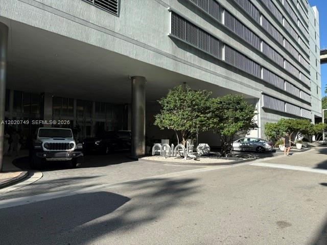 A silver Jeep is parked under the covered entrance of a large modern apartment building — 92 SW 3rd St # 1804, Miami FL 33130, MIAMI, FL