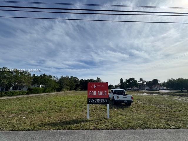 A white Jeep is parked on a vacant grassy lot with a for sale sign — 3494 S Jog Rd, Green Acres FL 33467, GREEN ACRES, FL