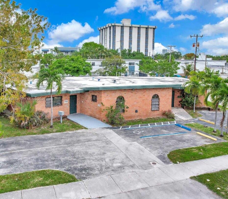 A low-rise brick building with a flat roof and an adjacent parking lot — 1747 NE 124th St, North Miami FL 33181, NORTH MIAMI, FL