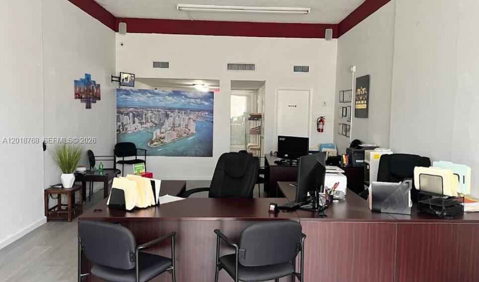 This office space features a large desk, multiple chairs, and a mural of a city — 402 NW 27 Ave, Miami FL 33125, MIAMI, FL