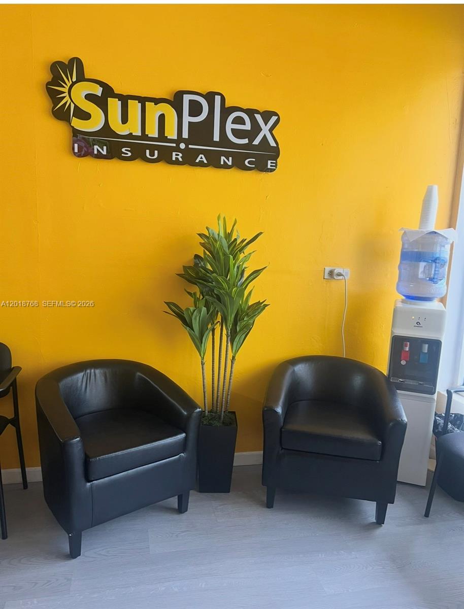 A waiting area features two black armchairs, a potted plant, and a water cooler — 402 NW 27 Ave, Miami FL 33125, MIAMI, FL