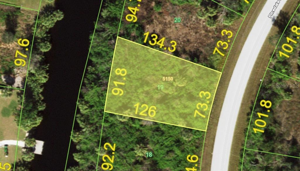 This is an aerial map showing a highlighted parcel of land with property boundary dimensions — 7529 PINEDALE DRIVE, PORT CHARLOTTE, FL