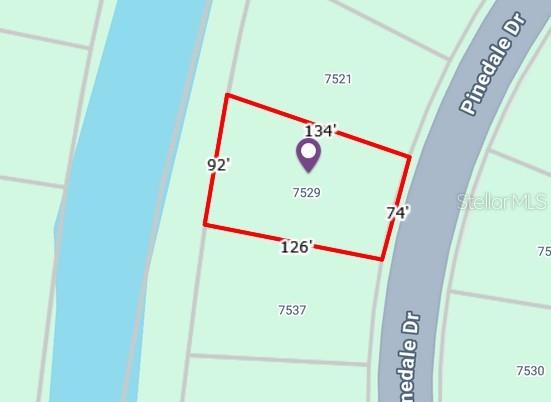 This map shows the property boundaries and dimensions of a residential lot on Pinedale Drive — 7529 PINEDALE DRIVE, PORT CHARLOTTE, FL
