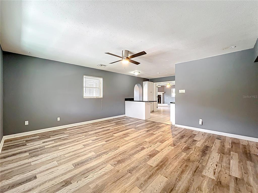 A living room with gray walls, wood-look flooring, and a ceiling fan — 2543 HATHAWAY DRIVE, COCOA, FL