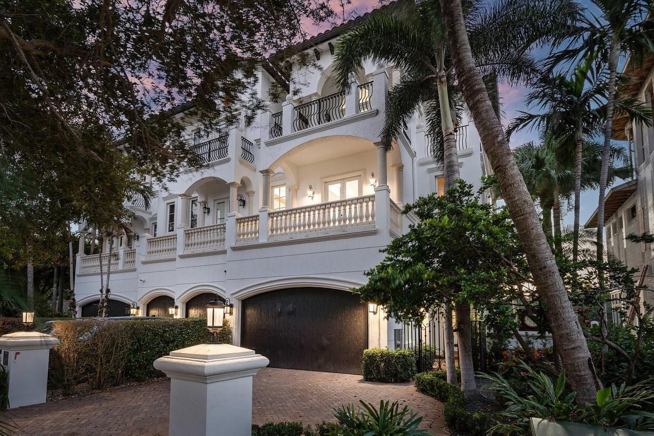 A multi-story white Mediterranean-style house features arched garage doors, balconies with balustrades, and palm trees — 549 NE 19th Avenue # C, Deerfield Beach FL 33441, DEERFIELD BEACH, FL