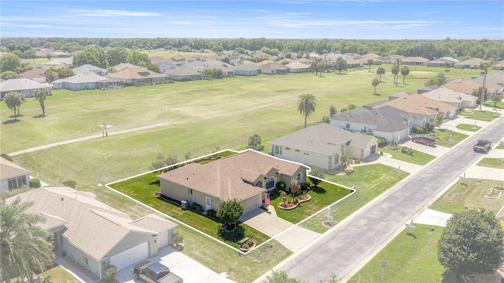 An aerial view shows a single-story house with a tan roof and lawn — 2081 NW 58TH COURT, OCALA, FL