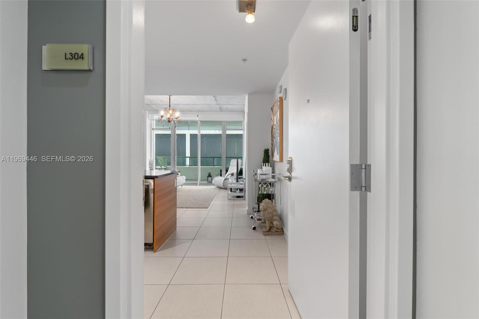 The view from an entryway shows a tiled hallway leading to an open-concept living area — 3301 NE 1st Ave # L0304, Miami FL 33137, MIAMI, FL