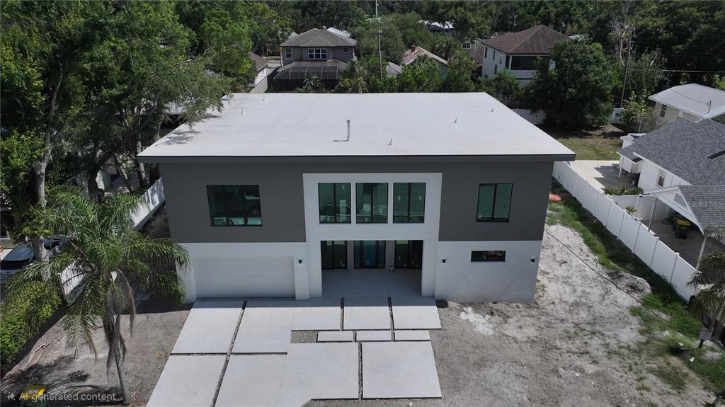 An aerial view of a modern two-story house with a flat roof and concrete driveway — 2258 ARLINGTON STREET, SARASOTA, FL