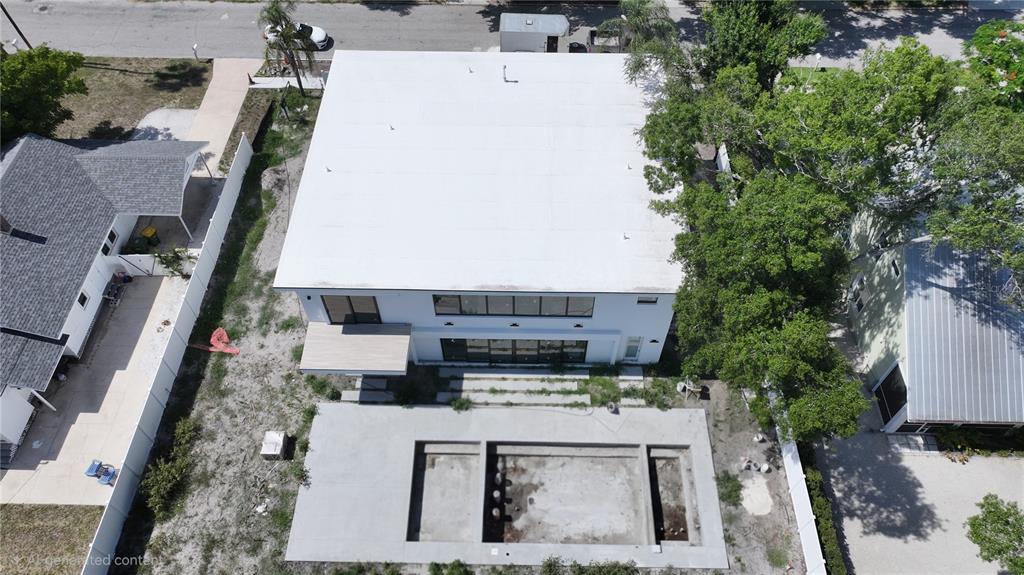 An aerial view shows a modern two-story house with a flat roof and an unfinished pool — 2258 ARLINGTON STREET, SARASOTA, FL