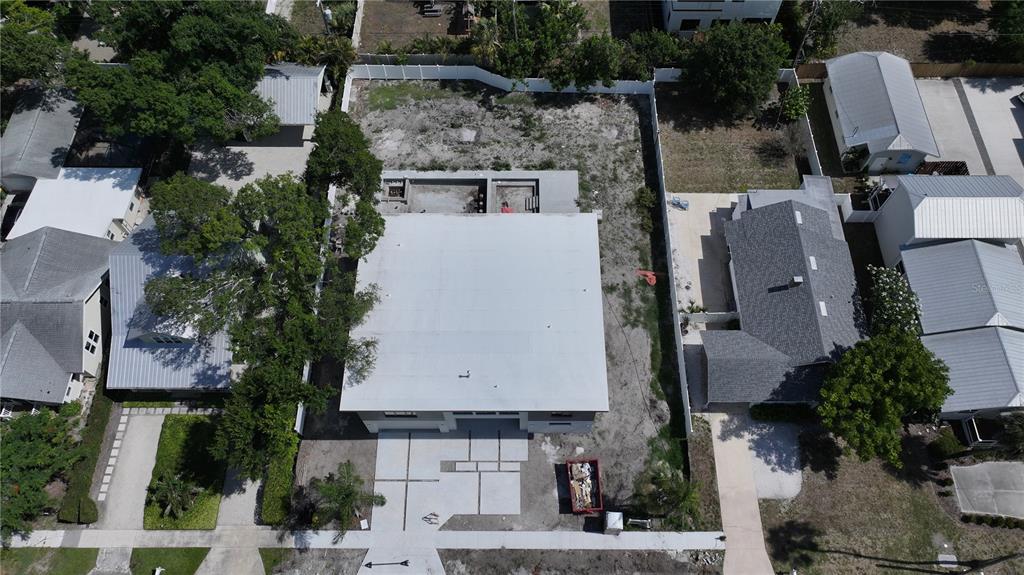 An aerial view shows a house under construction with a large flat roof and driveway — 2258 ARLINGTON STREET, SARASOTA, FL