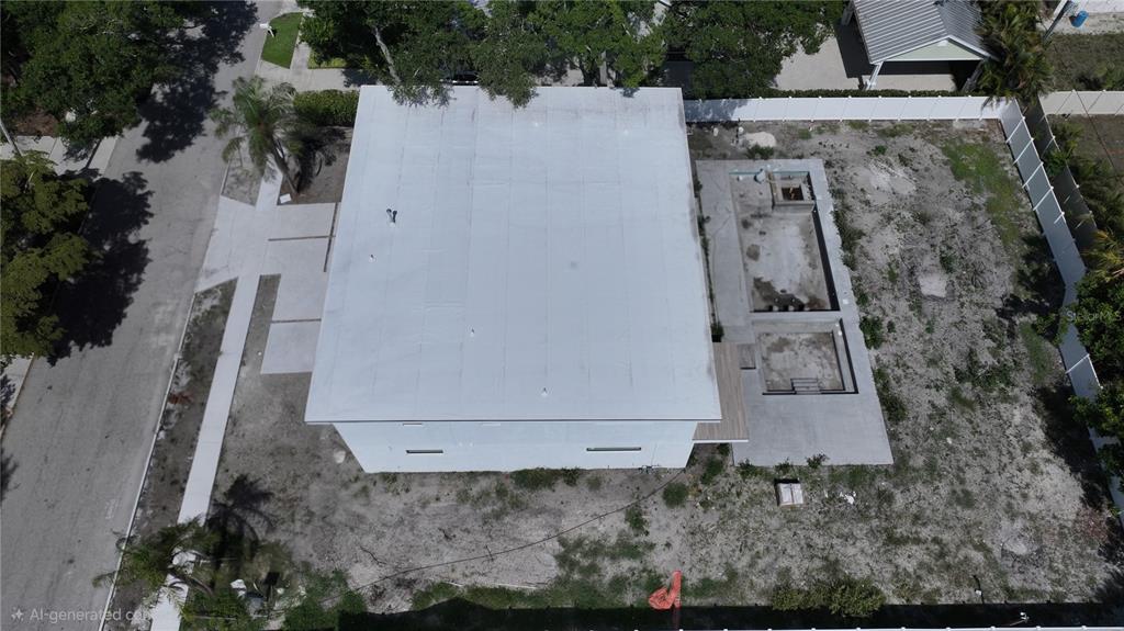An aerial view shows a flat-roofed house with an unfinished pool area and dirt yard — 2258 ARLINGTON STREET, SARASOTA, FL