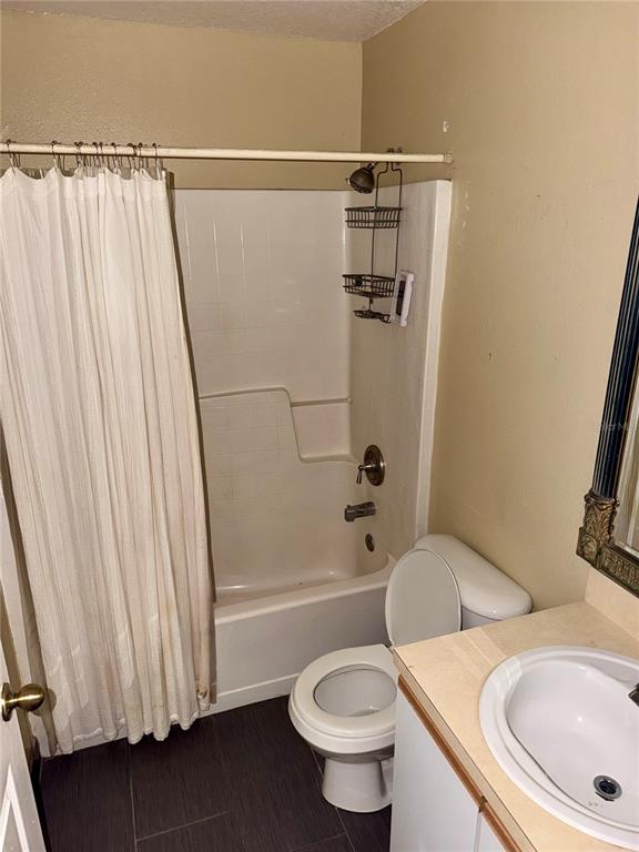 A bathroom features a shower-tub combination, a toilet, and a vanity with a sink — 1326 AGUACATE COURT, ORLANDO, FL