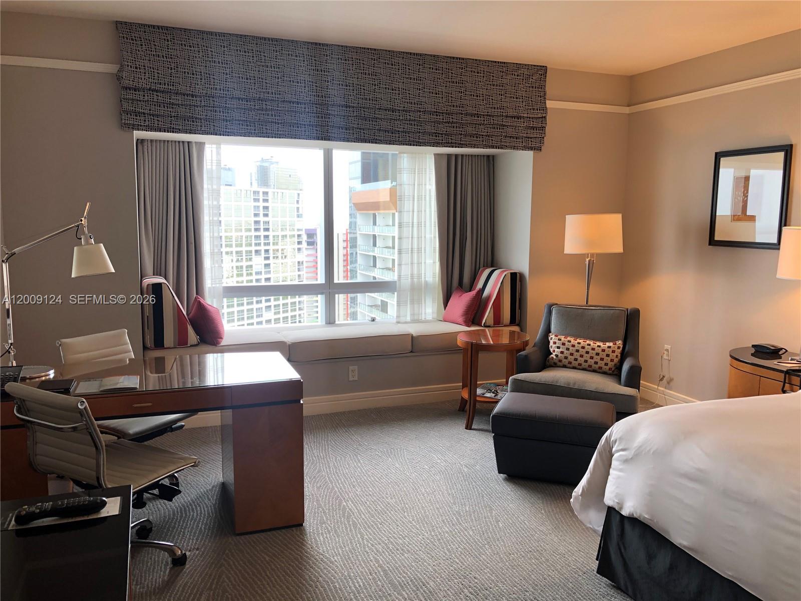 A hotel room features a desk, a window seat, an armchair with ottoman, and city views — 1435 Brickell Ave # 3505, Miami FL 33131, MIAMI, FL