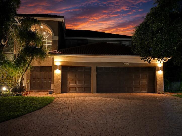 A two-story house with a three-car garage and a paved driveway at sunset — 12781 Yardley Drive, Boca Raton FL 33428, BOCA RATON, FL