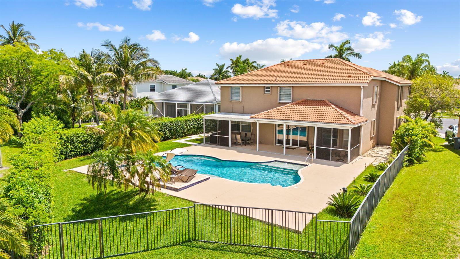 An aerial view of a two-story house with a backyard pool and screened-in patio — 12781 Yardley Drive, Boca Raton FL 33428, BOCA RATON, FL