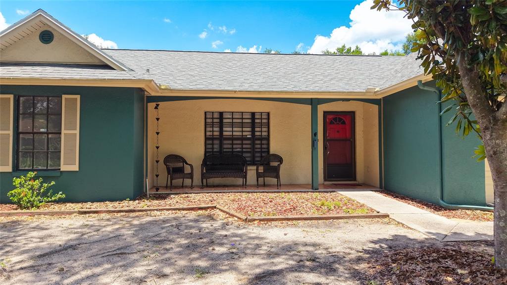 A single-story house with a green and tan exterior, a two-car garage, and a wooden fence — 1048 MALLETWOOD DRIVE, BRANDON, FL