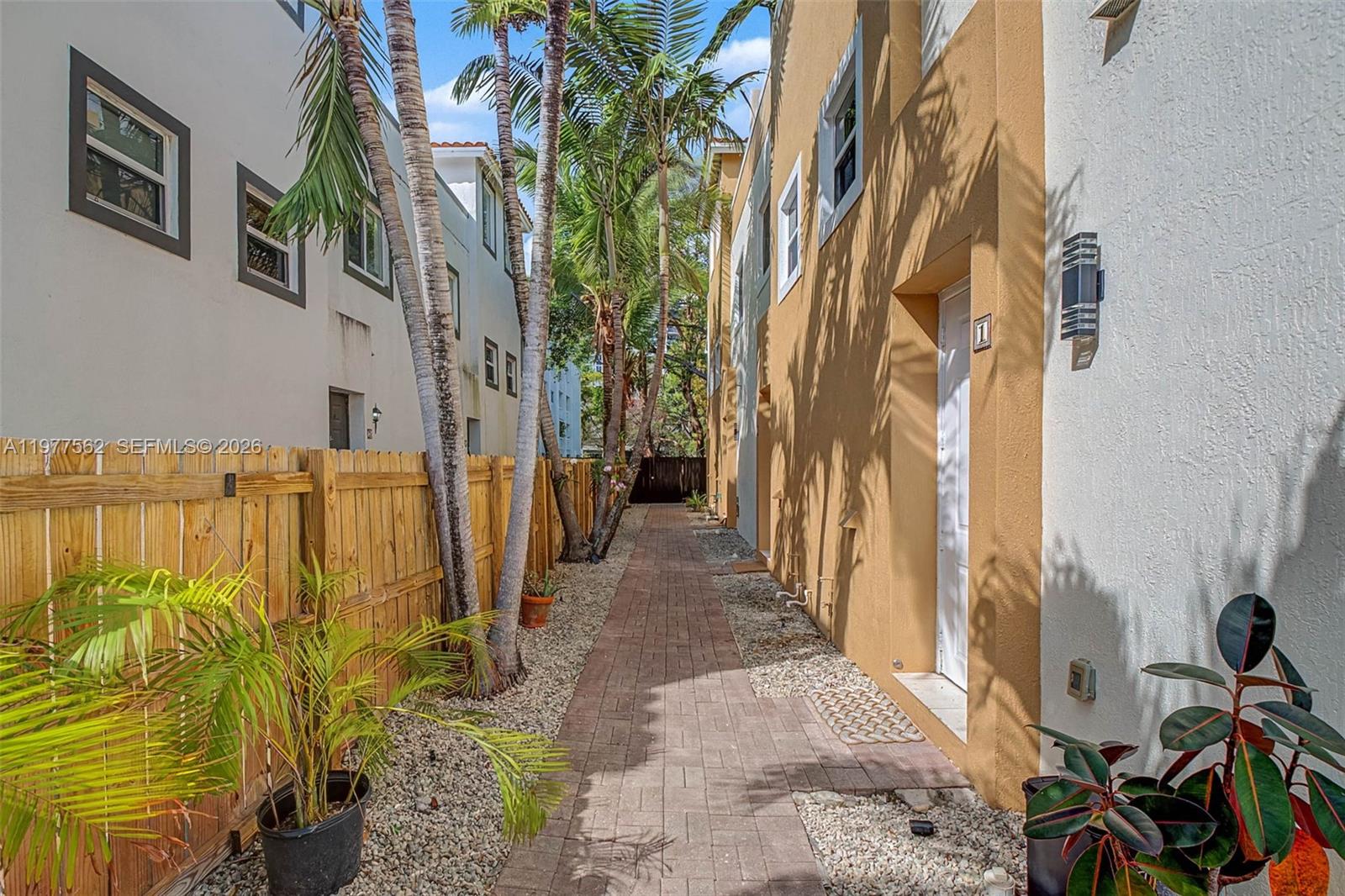 A white door with a number one sign sits on the side of a building — 2945 Coconut Ave, Miami FL 33133, MIAMI, FL