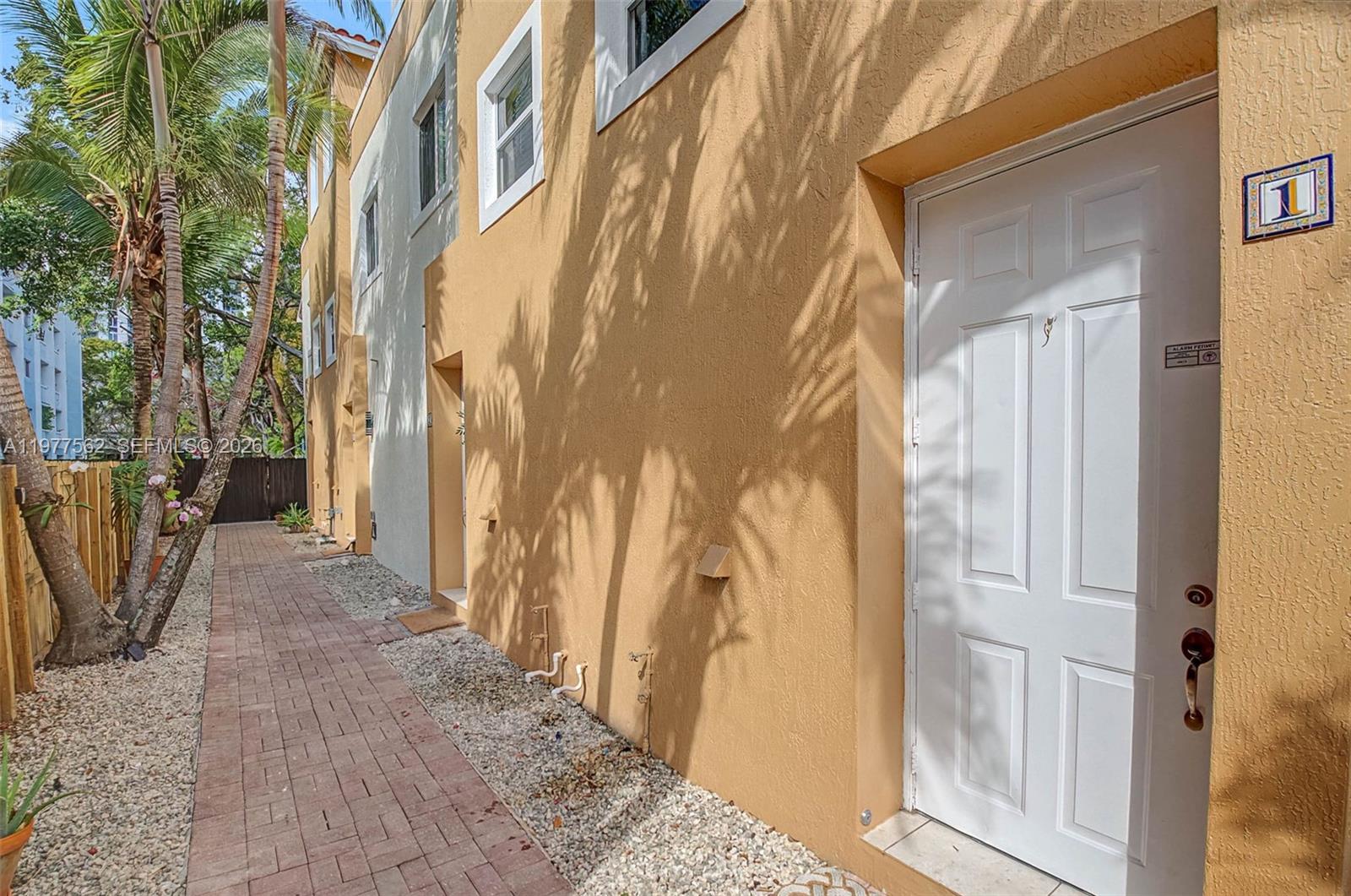 A white front door with a wreath and house number two on a stucco building — 2945 Coconut Ave, Miami FL 33133, MIAMI, FL