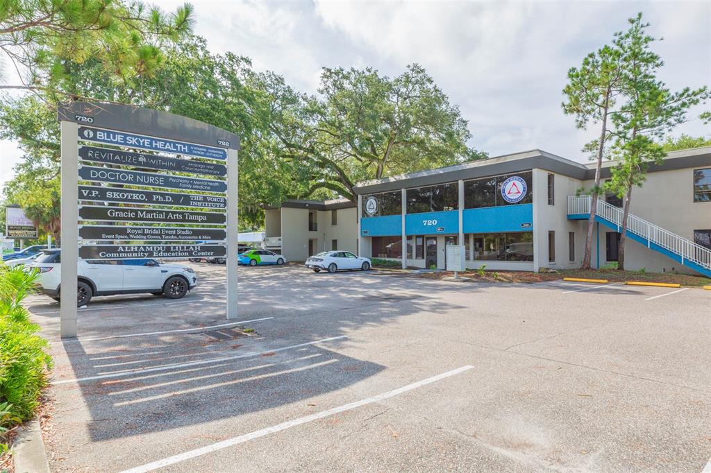 A two-story commercial office building with a parking lot and a directory sign in front — 718-722 W DR MARTIN LUTHER KING JR BOULEVARD, TAMPA, FL