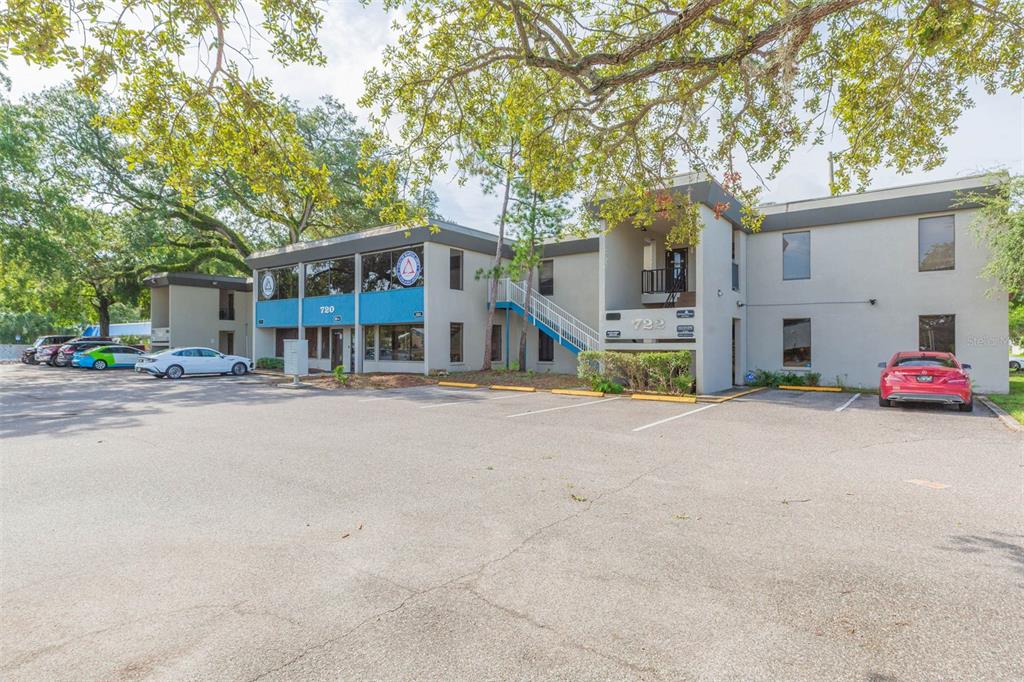 A two-story commercial office building with a parking lot and large trees in front — 718-722 W DR MARTIN LUTHER KING JR BOULEVARD, TAMPA, FL