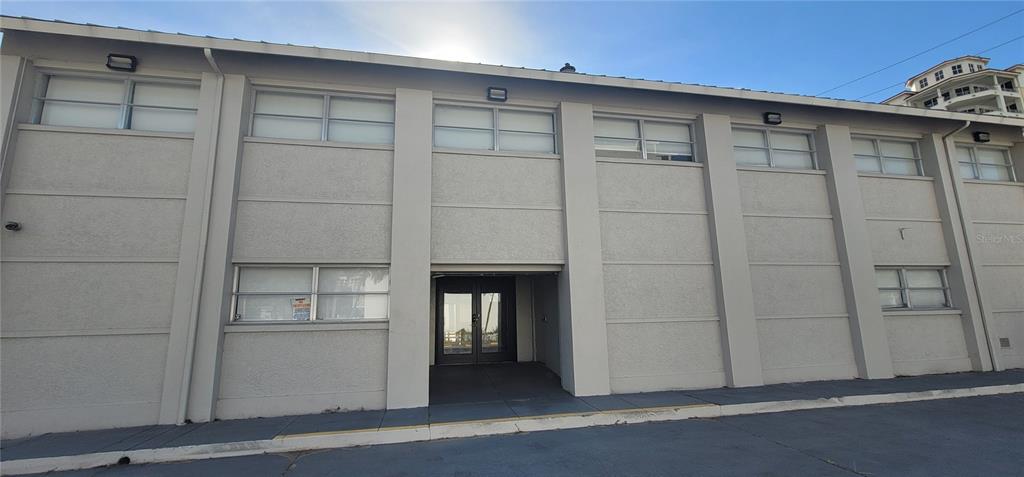 The exterior of a two-story commercial building features a recessed entrance and multiple rectangular windows — 227 CENTRAL AVENUE, SARASOTA, FL