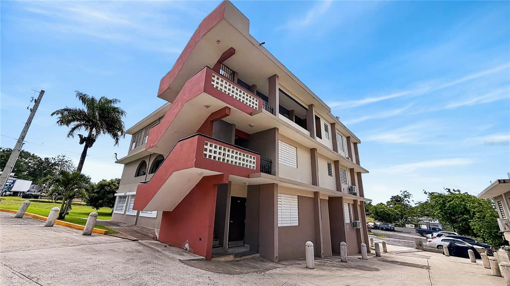A multi-story apartment building with exterior staircases and balconies under a blue sky — 120 BO HATO TEJAS, BAYAMON, PR