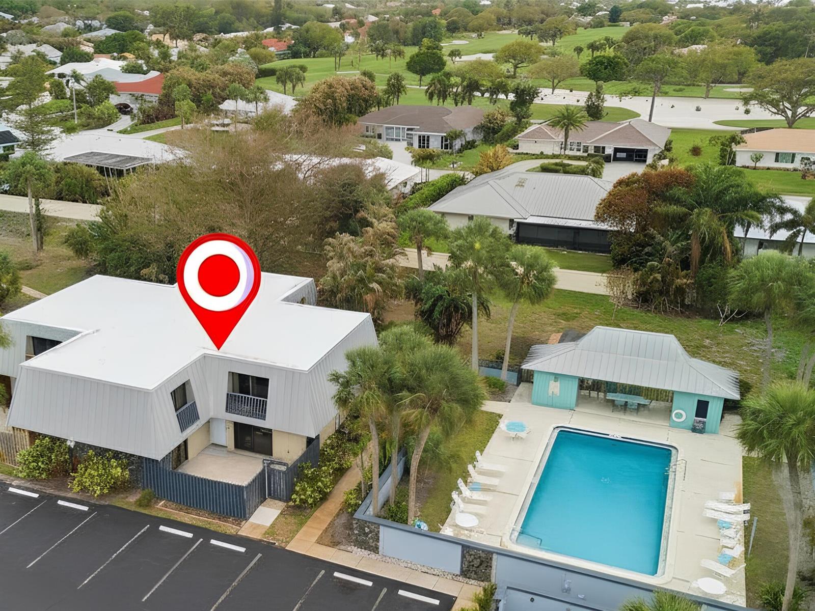 An aerial view shows a multi-story building with a pool and a parking lot — 3832 SE Jefferson Street, Stuart FL 34997, STUART, FL