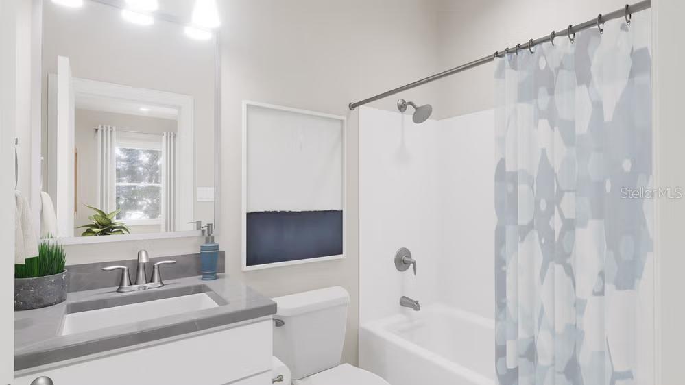A modern bathroom features a white vanity with a gray countertop, toilet, and shower-tub combo — 13307 PEACEFUL MELODY DRIVE, WINTER GARDEN, FL